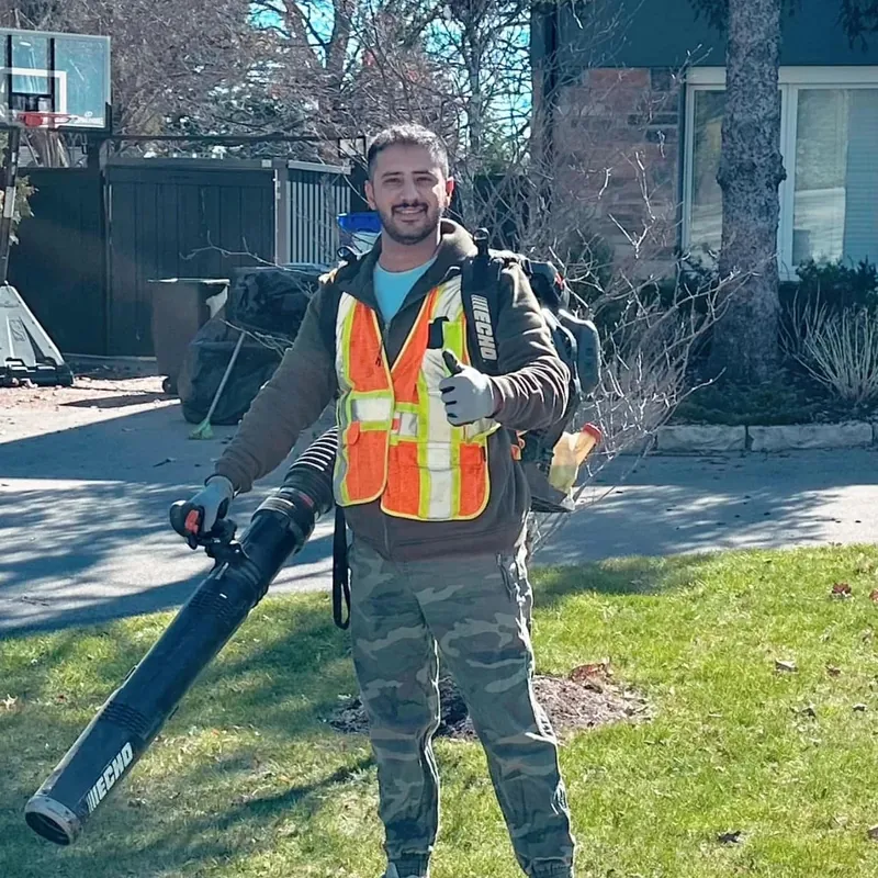 Lawn By Moe crew member with a leaf blower
